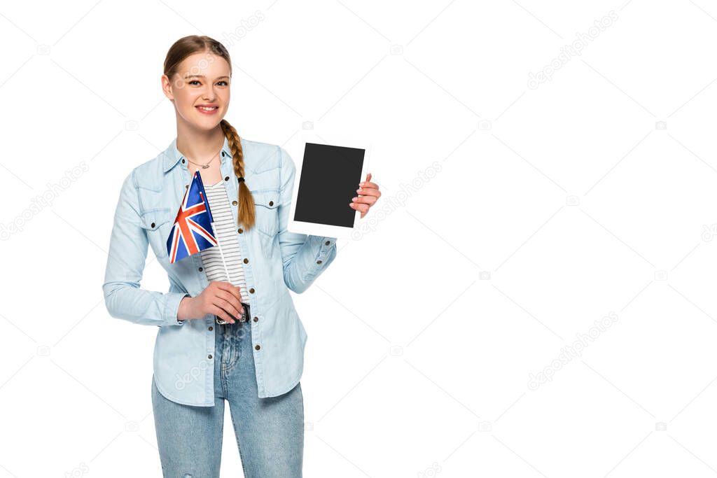 smiling pretty girl with braid holding digital tablet with blank screen and uk flag isolated on white