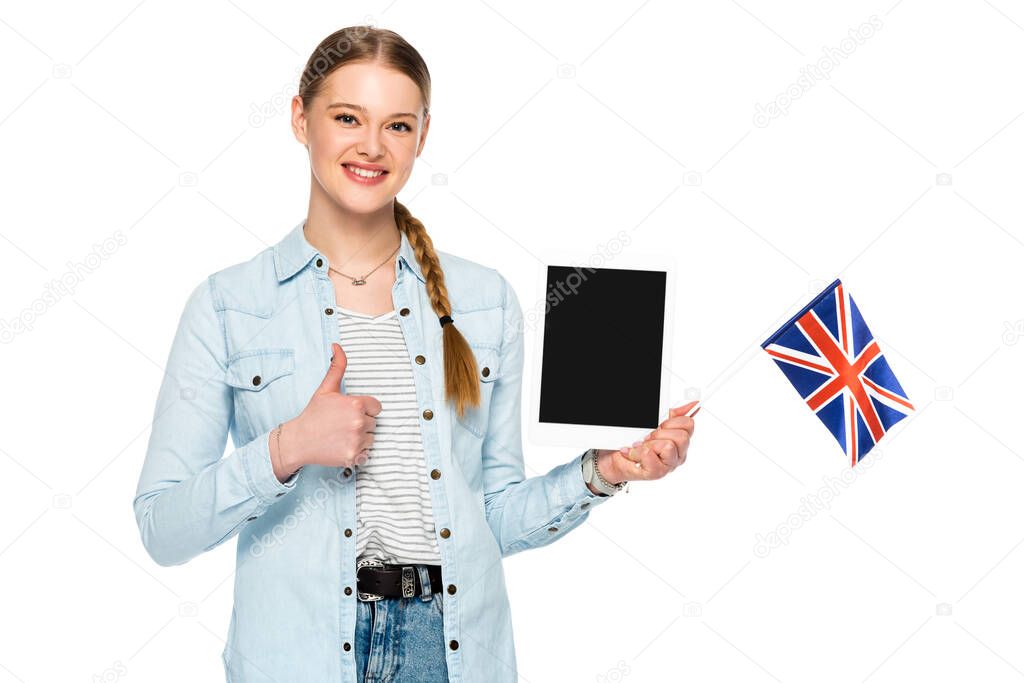 smiling pretty girl with braid holding digital tablet with blank screen and uk flag while showing thumb up isolated on white