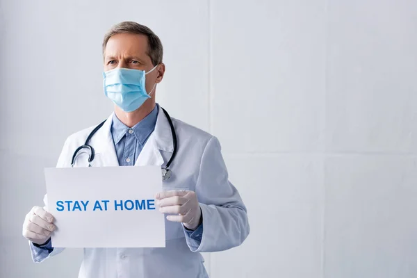 Middle Aged Doctor Latex Gloves Holding Placard Stay Home Lettering — Stock Photo, Image
