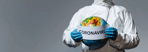 Panoramic Shot Man Hazmat Suit Holding Globe Paper Coronavirus Lettering — Stock Photo, Image