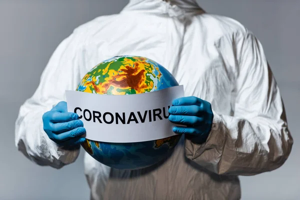 Cropped View Man Hazmat Suit Holding Globe Paper Coronavirus Lettering — Stock Photo, Image