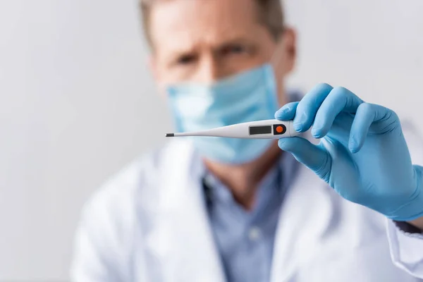 Selective Focus Mature Doctor Latex Glove Holding Digital Thermometer Isolated — Stock Photo, Image