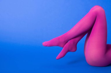 Mor taytlı, bacak bacak üstüne atmış, mavi bir model.