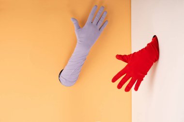 cropped view o woman in colorful gloves on orange and white clipart