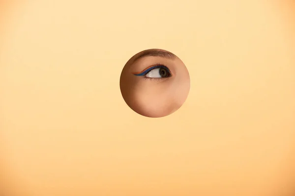 Cropped View Woman Looking Away Hole Pastel Orange — Stock Photo, Image