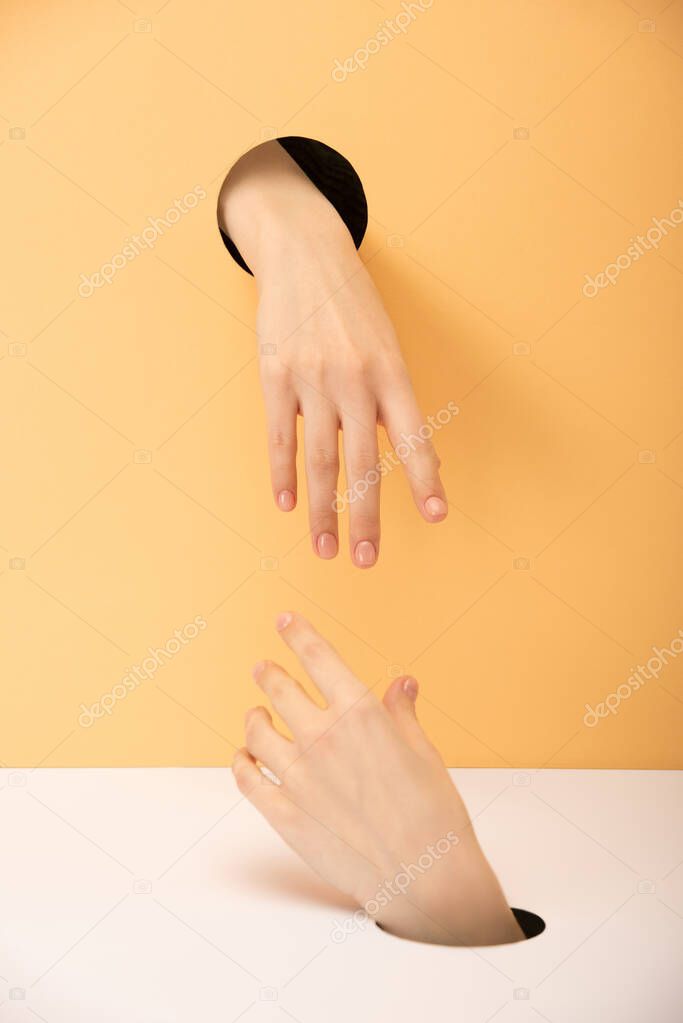 cropped view of hands on orange and white 