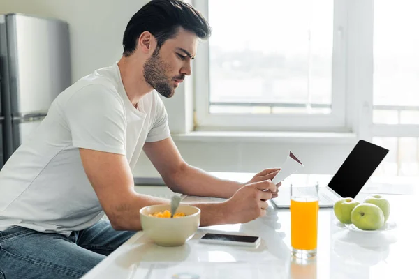 Side View Handsome Man Holding Paper Cereals Orange Juice Kitchen — Stock Photo, Image