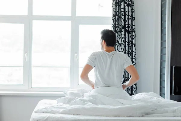 Back View Man Looking Window While Sitting Bed Home — Stock Photo, Image