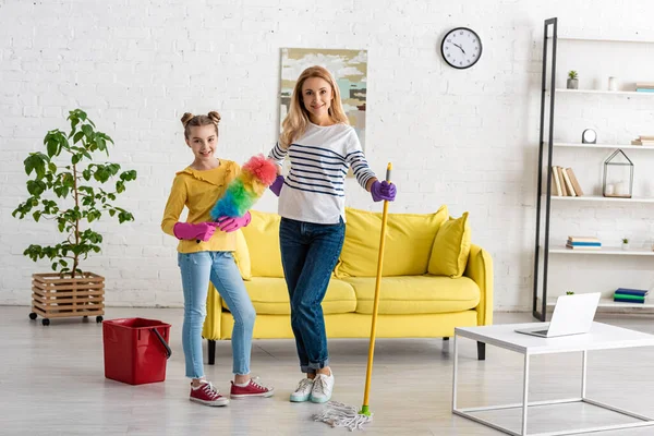 Mother Cute Daughter Feather Duster Mop Smiling Looking Camera Bucket — Stock Photo, Image