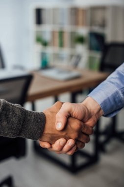 Çok ırklı iş adamlarının ofiste el sıkışması 