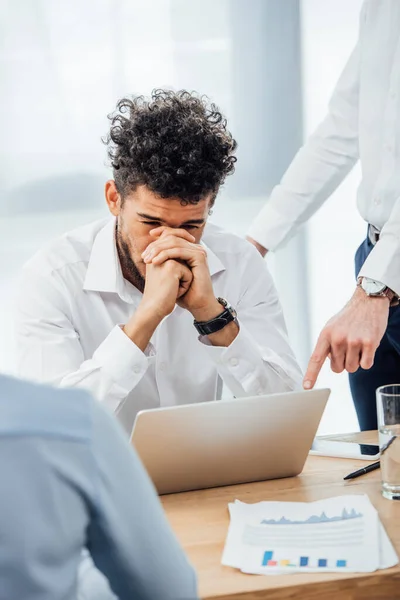 Selective Focus Businessman Pointing Laptop Sad African American Colleague Office — Stock Photo, Image