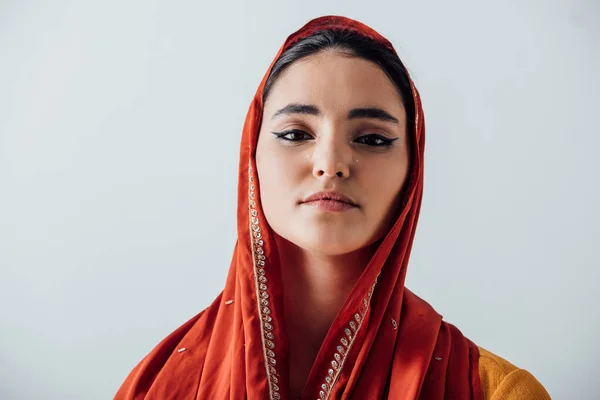 Indian woman in sari crying and looking at camera isolated on grey