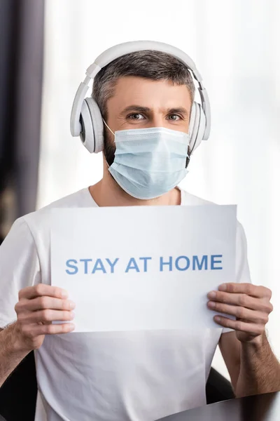 Man Medical Mask Headphones Holding Card Stay Home Lettering Living — Stock Photo, Image