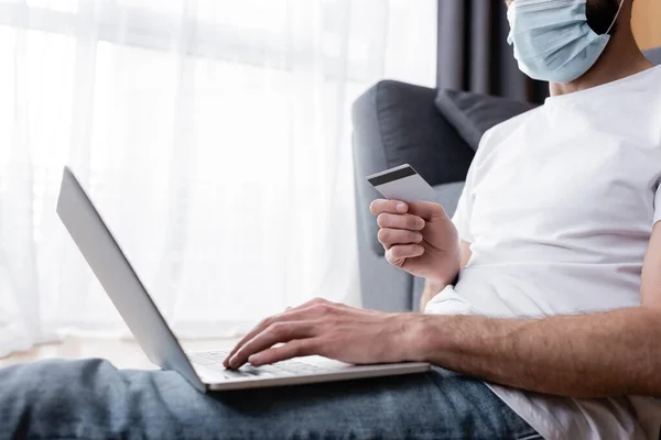 Cropped View Man Medical Mask Using Laptop Credit Card Home — Stock Photo, Image