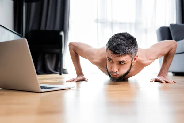 Surface Level Muscular Man Doing Push Ups Laptop Floor Home — Stock Photo, Image