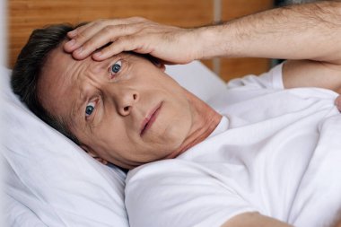 depressed man looking at camera while feeling unwell  clipart