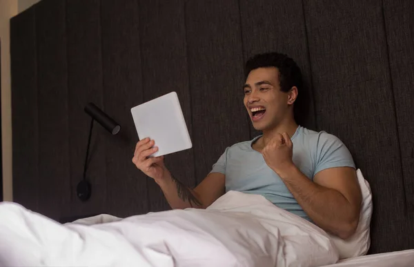 Excited Handsome Mixed Race Man Using Digital Tablet Bed Quarantine — Stock Photo, Image