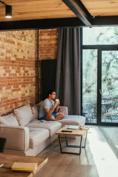 Handsome Mixed Race Man Holding Cup Coffee Sofa Living Room — Stock Photo, Image