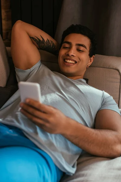 Smiling Mixed Race Man Chilling Using Smartphone Sofa Quarantine — Stock Photo, Image