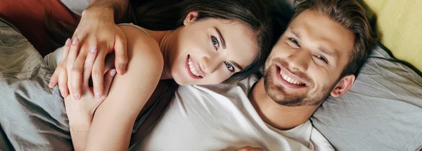 Panoramic Shot Happy Couple Hugging Bed Looking Camera — Stock Photo, Image