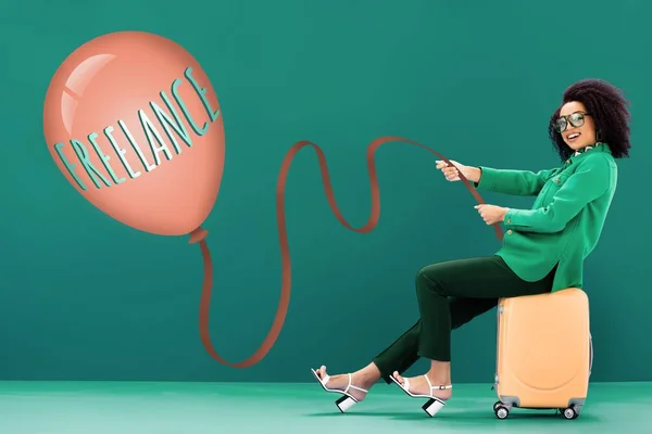 Smiling African American Woman Holding Balloon Freelance Lettering While Sitting — Stock Photo, Image