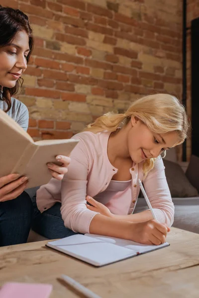 Selective Focus Woman Holding Book While Kid Writing Notebook Coffee — Stock Photo, Image