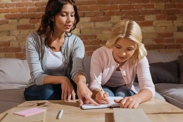 Selective Focus Mother Pointing Notebook While Daughter Writing Books Coffee — Stock Photo, Image