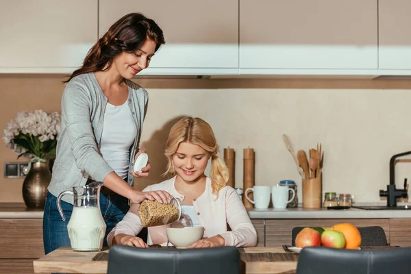 Selective Focus Smiling Mother Pouring Cereals Bowl Daughter Table — Stock Photo, Image