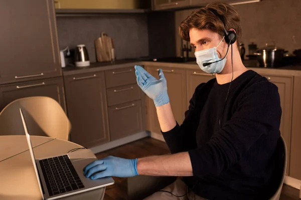 Teleworker Medical Mask Latex Gloves Pointing Hand While Using Headset — Stock Photo, Image