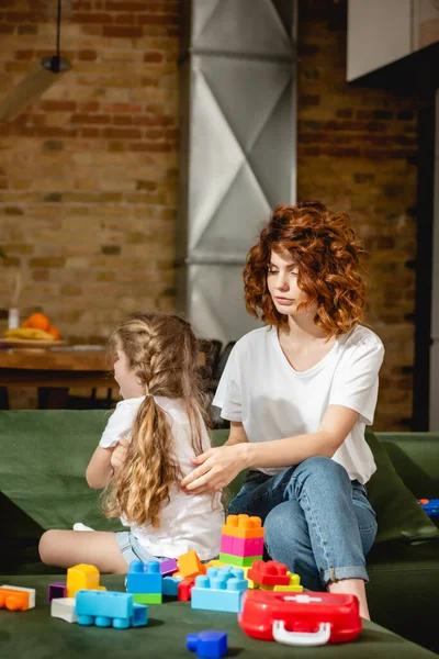 Curly Mother Looking Offended Daughter Building Blocks — Stock Photo, Image