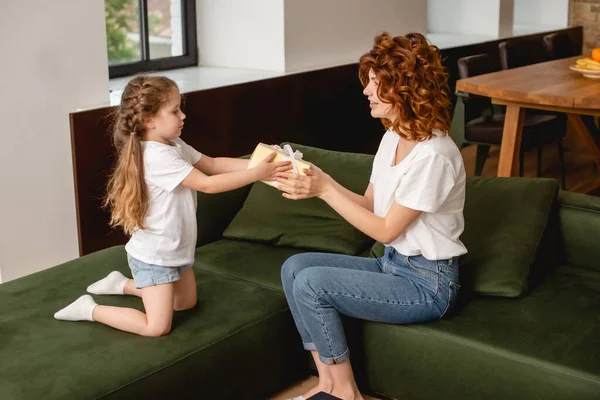 Side View Cute Kid Giving Present Curly Mother — Stock Photo, Image