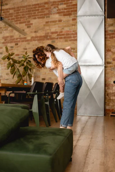 Curly Redhead Mother Piggybacking Cute Daughter — Stock Photo, Image