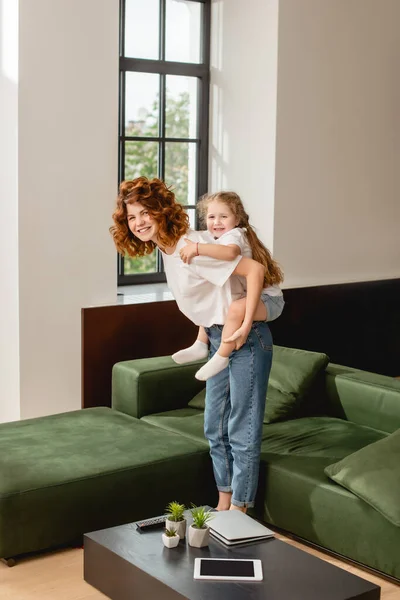 Curly Mother Piggybacking Happy Daughter — Stock Photo, Image