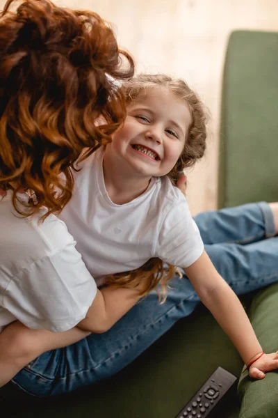 Overhead View Curly Mother Kissing Cheek Happy Daughter — Stock Photo, Image