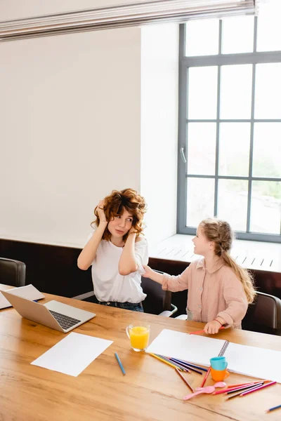 Krullend Freelancer Moeder Dekking Van Oren Buurt Laptop Dochter Thuis — Stockfoto