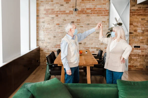 Happy Senior Couple Medical Masks Dancing Home Self Isolation — Stock Photo, Image