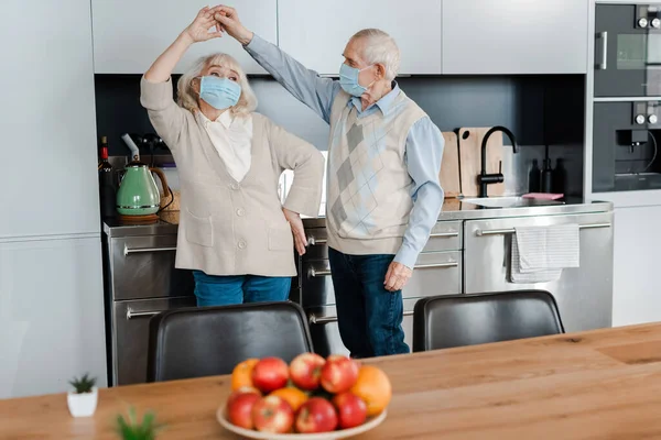 Senior Couple Medical Masks Dancing Kitchen Apples Self Isolation — Stock Photo, Image