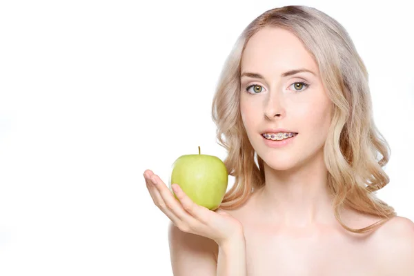 Woman holding apple on hand — Stock Photo