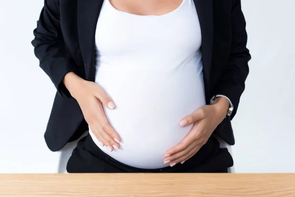 Schwangere Geschäftsfrau berührt ihren Bauch — Stockfoto