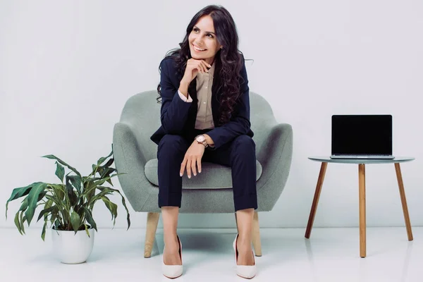 Businesswoman sitting in armchair — Stock Photo