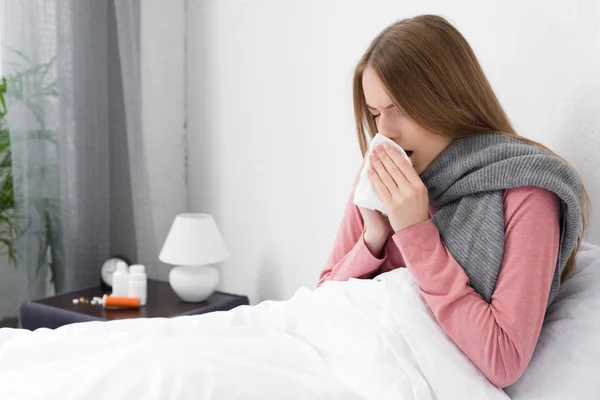 Sick girl wiping nose — Stock Photo