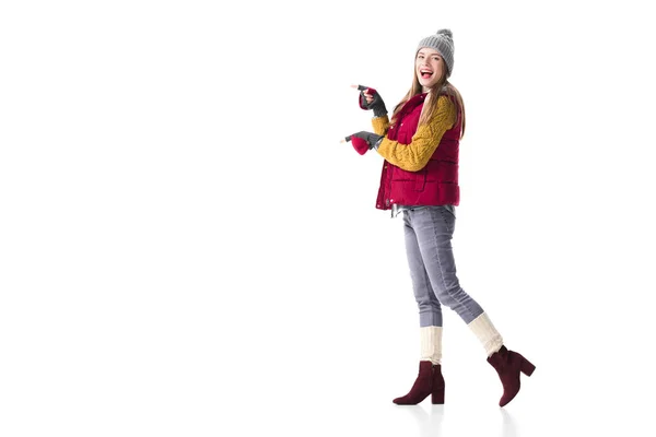 Woman in winter clothes pointing at something — Stock Photo