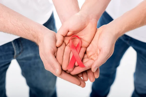 Gay couple holding aids ribbon — Stock Photo