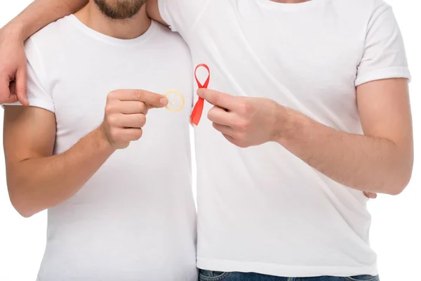 Gay couple with aids ribbon and condom — Stock Photo