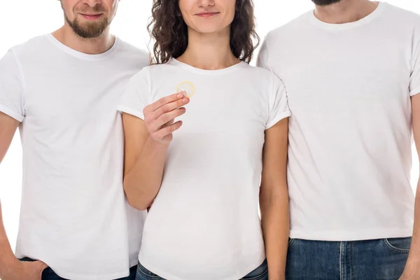 Woman holding condom with men on sides — Stock Photo