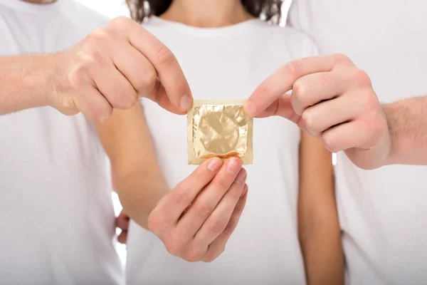 Group of people holding condom — Stock Photo