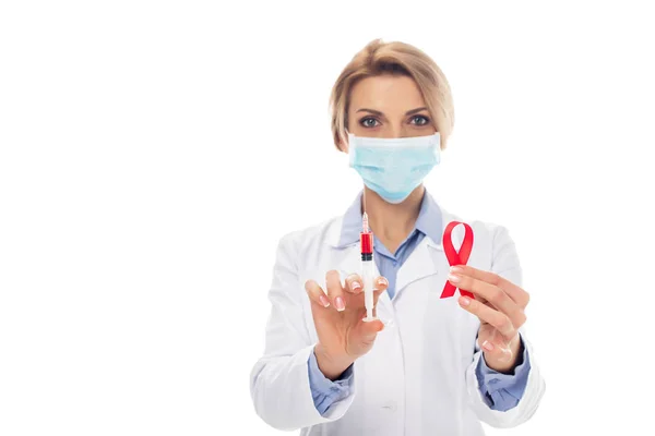 Doctor with syringe and aids ribbon — Stock Photo