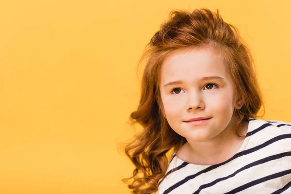 Portrait of pretty kid looking away isolated on yellow — Stock Photo