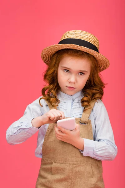 Portrait of little child using smartphone isolated on pink — Stock Photo