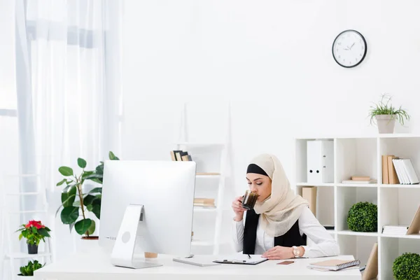 Porträt einer arabischen Geschäftsfrau, die am Arbeitsplatz im Büro Kaffee trinkt — Stockfoto